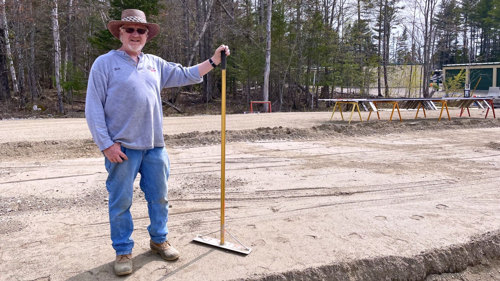 Blair West poses for a photo during a pause in grading his land to build another storage facility.