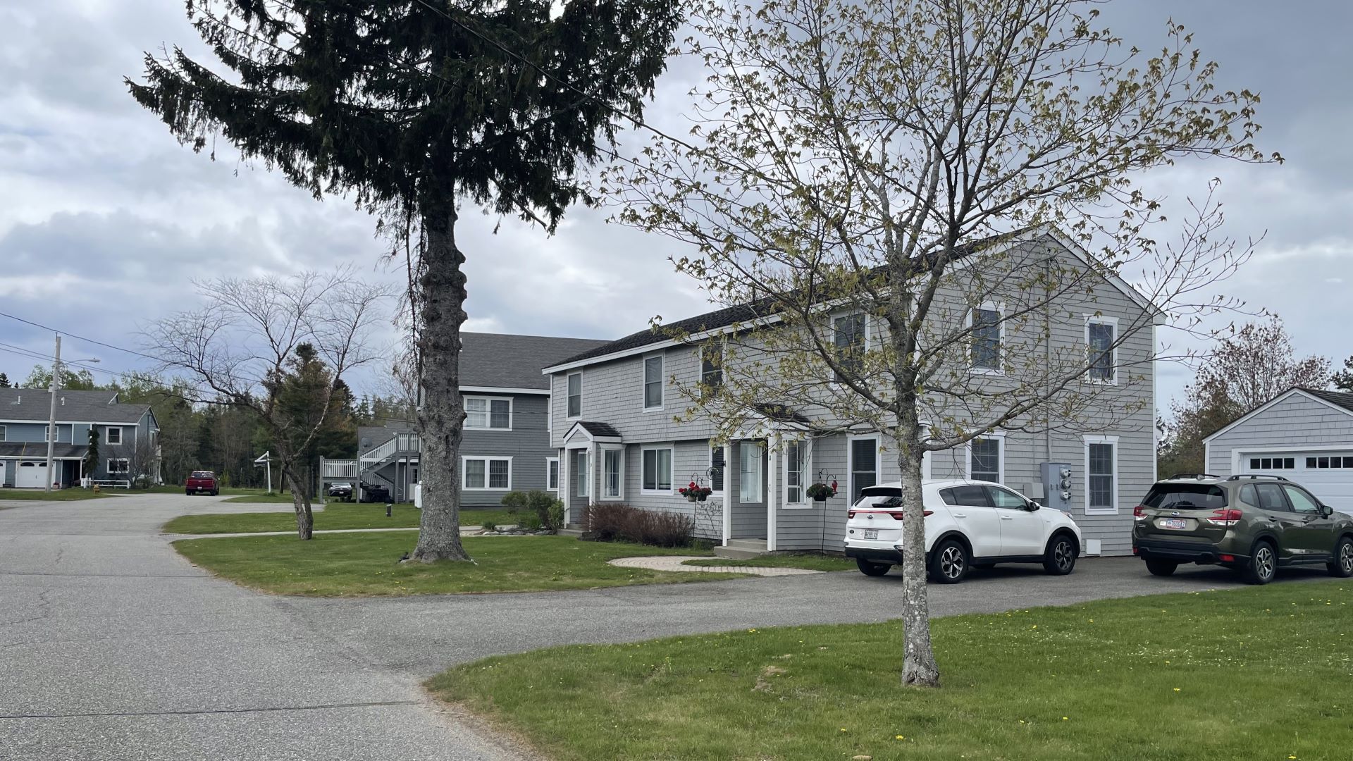 A street view inside the Beachwood Bay Estates condominium. Several gray condominium buildings are shown in the photo.