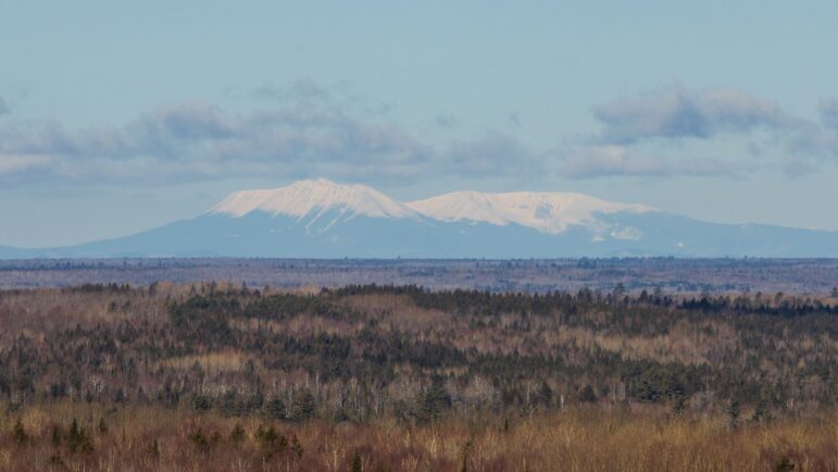 Mt. Katahdin is shown off in the cloudy distance.
