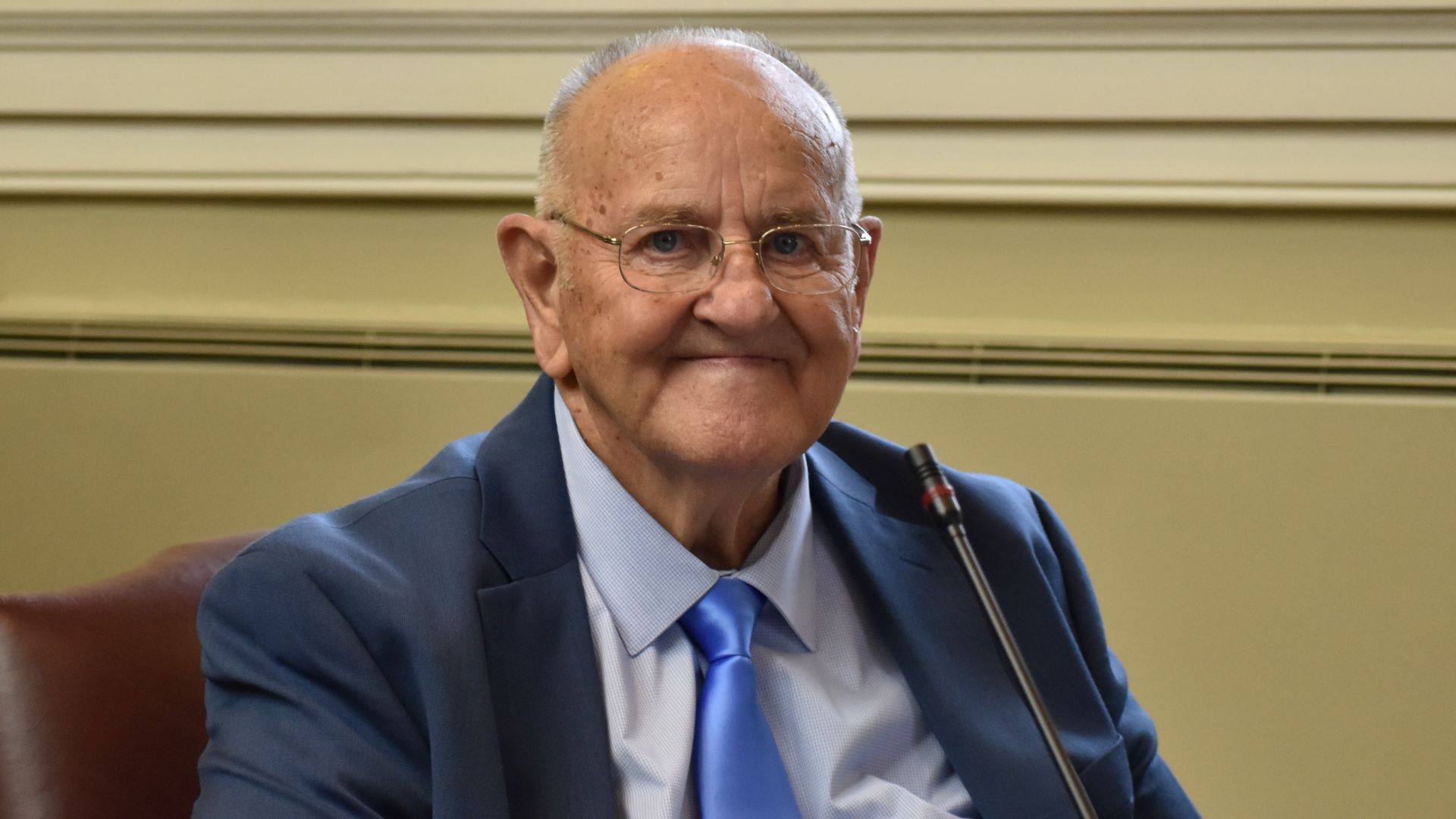 Sawin Millett poses for a photo while sitting in his seat within the state house
