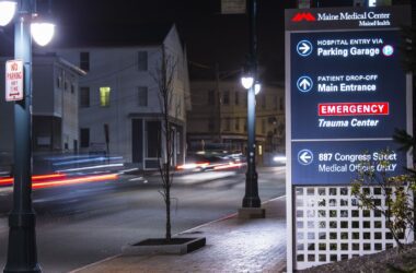 A sign outside a Maine Medical Center complex pointing individuals towards the correct buildings.