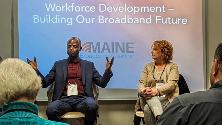 Two individuals on a panel at the Maine Broadband Summit.
