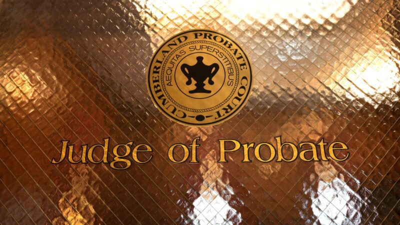 A glass door with a gold tint and the phrase "Judge of Probate" across the glass door. The seal of the Cumberland Probate Court appears above the phrase.