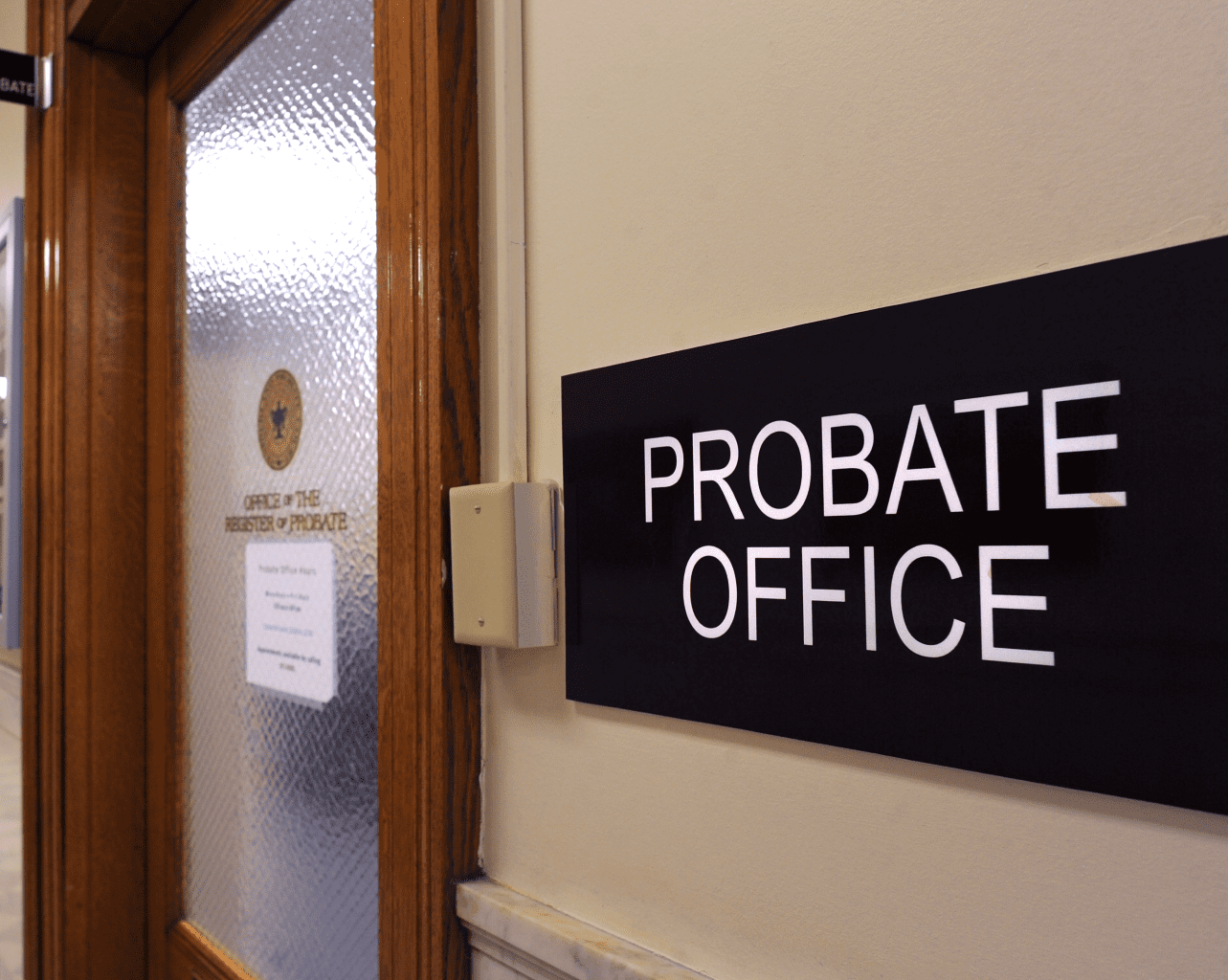 A black sign reading "Probate Office" is attached to the wall outside the doorway to the office.