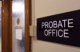 A black sign reading "Probate Office" is attached to the wall outside the doorway to the office.
