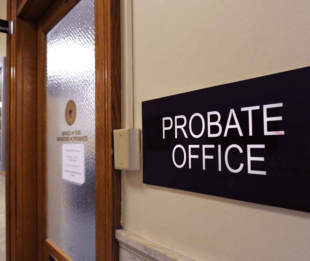 A black sign reading "Probate Office" is attached to the wall outside the doorway to the office.