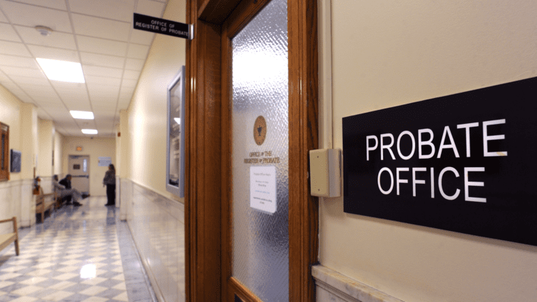A black sign reading "Probate Office" is attached to the wall outside the doorway to the office.