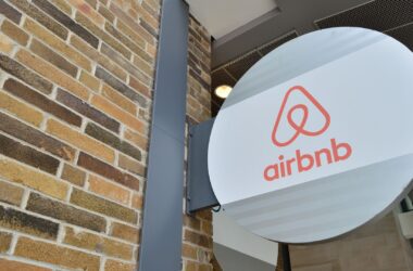 An airbnb sign with its logo attached to a building.