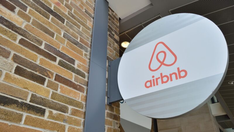 An airbnb sign with its logo attached to a building.