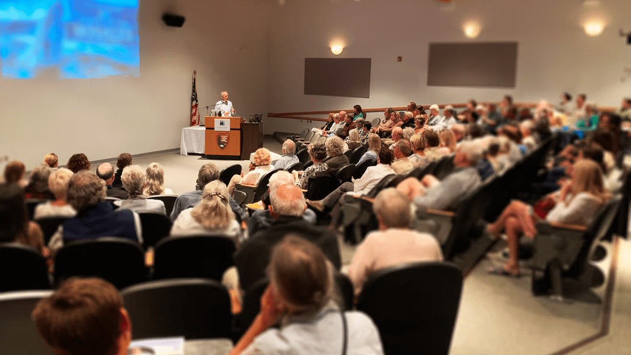 Brian Skerry gives a lecture to a room full of attendees.