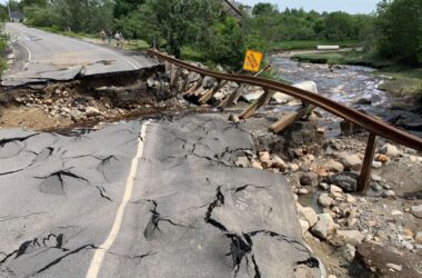 Heavy rains washed out a roadway and guardrails that went over a creek