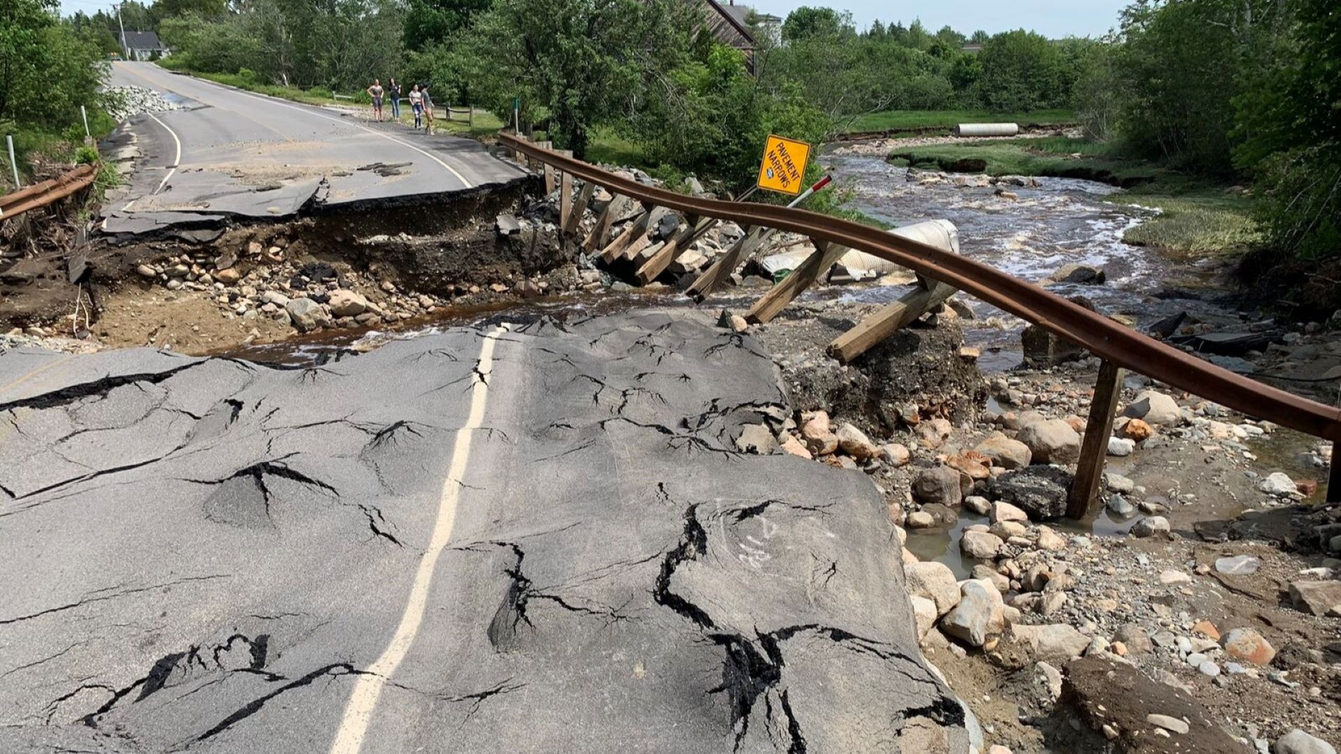 Heavy rains washed out a roadway and guardrails that went over a creek