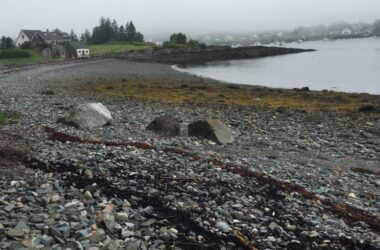 Coastline in Cutler, Maine with house in background.