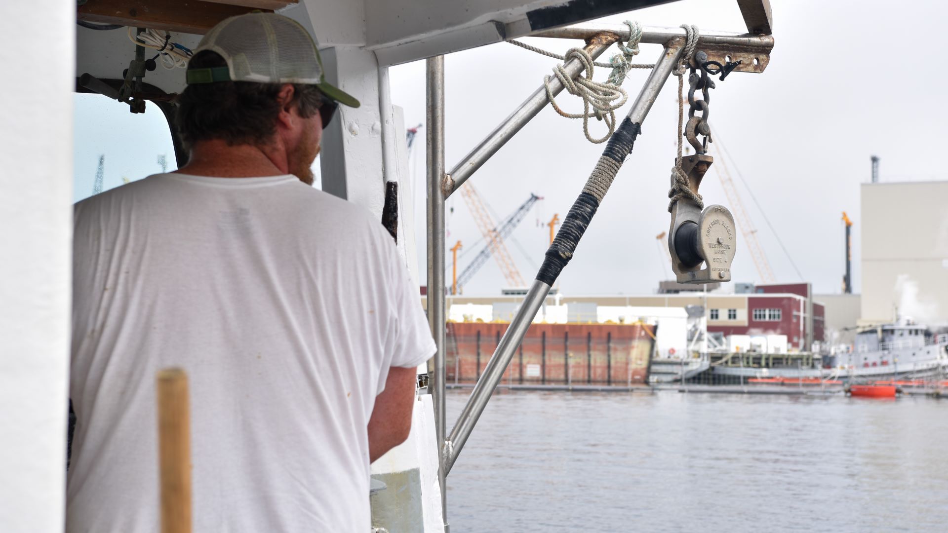 Chris Tobey looks to the water while on his lobster boat.