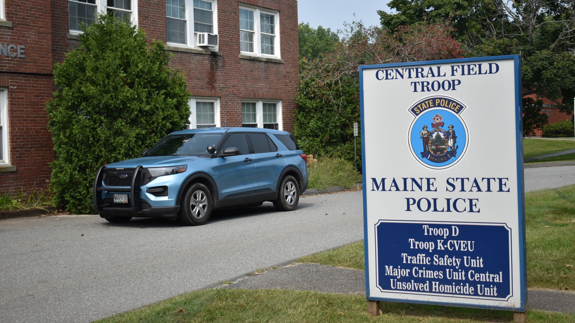 A cruiser is parked outside a Maine State Police building.