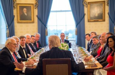 Many individuals, including Donald Trump and Leonard Leo, sit around a dinner table in the White House.