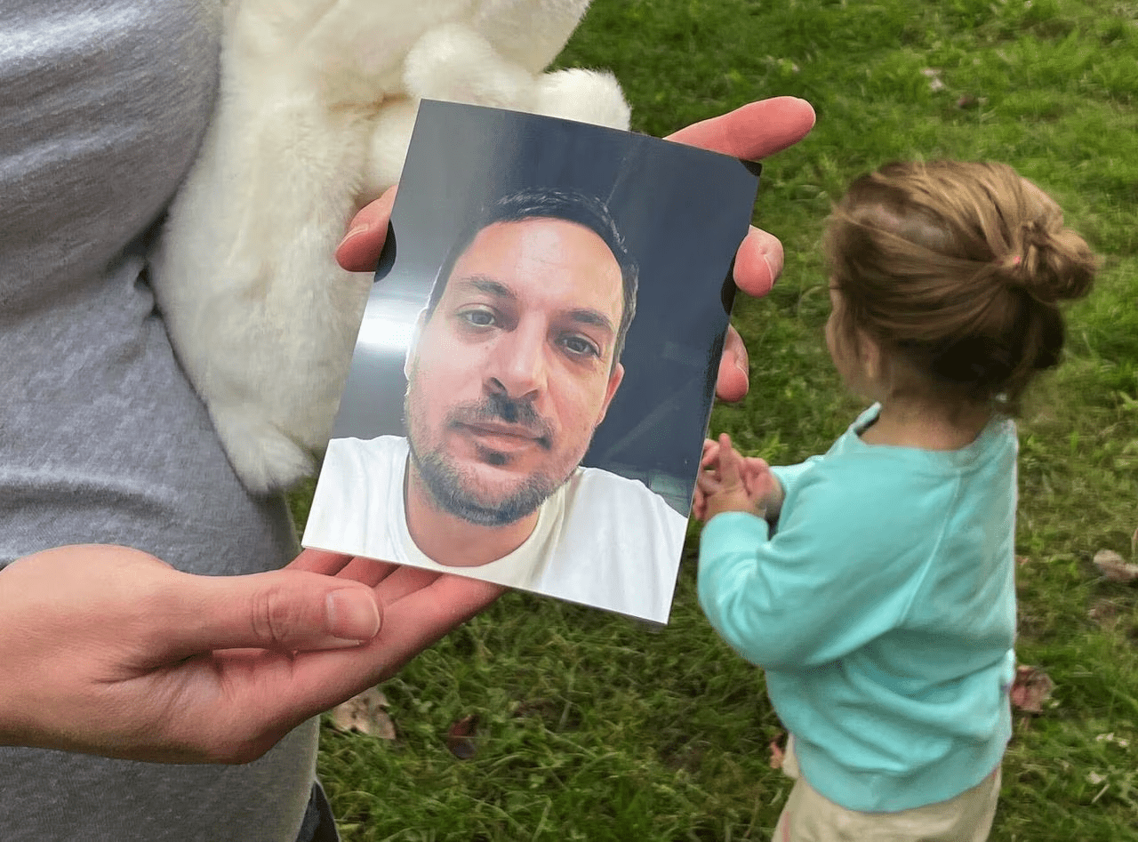 The wife of Maxx Hathaway shows a photo of him.
