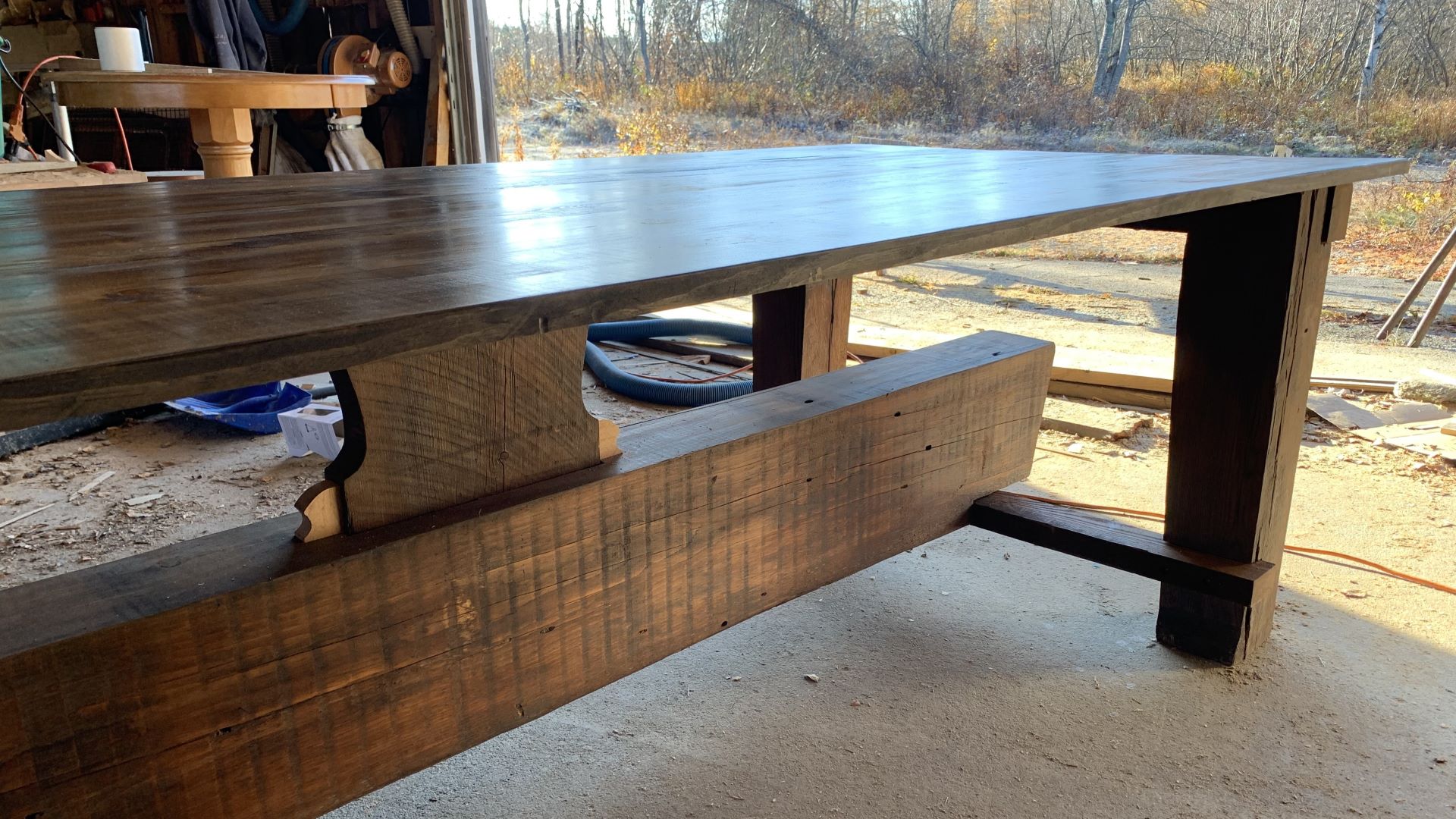 A brown table constructed by Jamie Moore sits in his workshop.