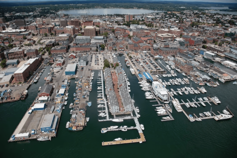 An aerial photo of Commercial Street and the waters surrounding the buildings of Portland.