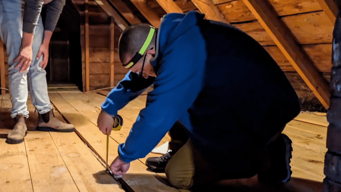 An energy auditor taking a measurement