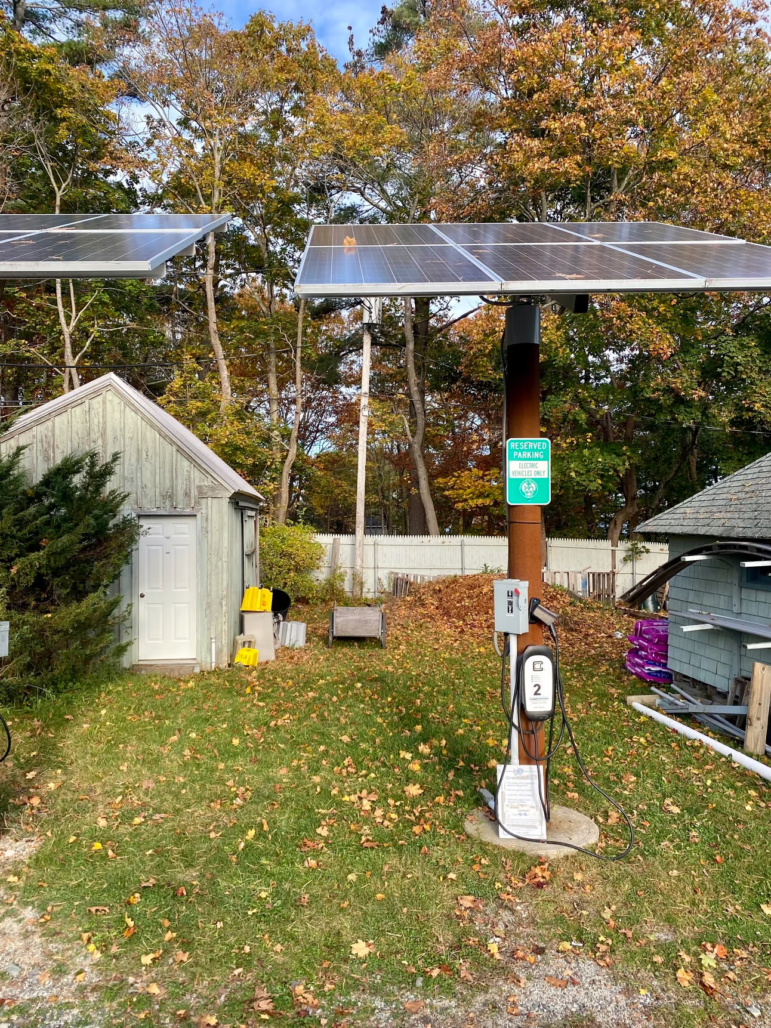 an electric vehicle charger seen in a backyard