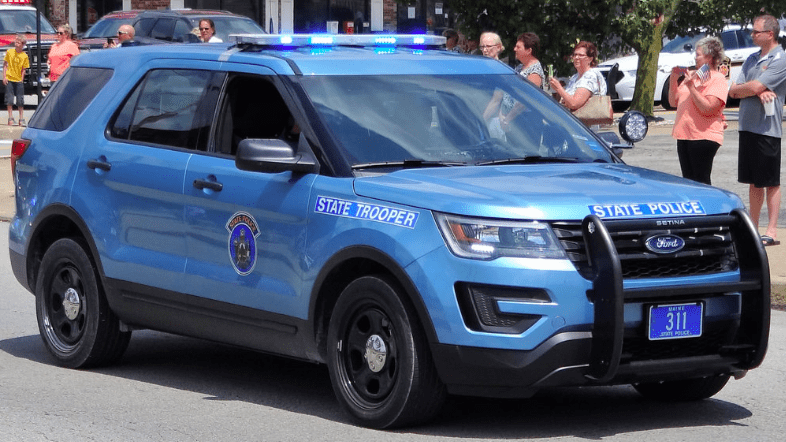 A light blue Maine State Police vehicle.