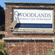 The sign for Woodlands Memory Care of Rockland at the facility's entrance