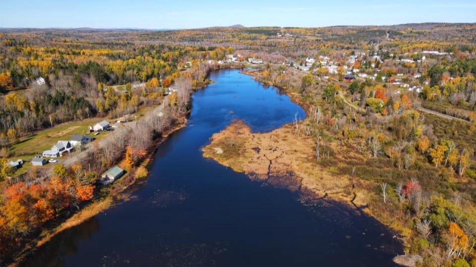 An aerial view of Danforth, Maine, including land and water.