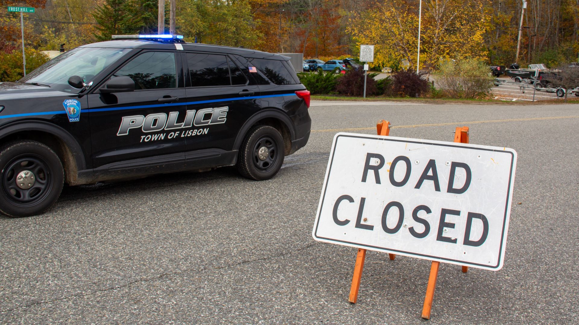 A Town of Lisbon police cruiser next to a road closure sign.