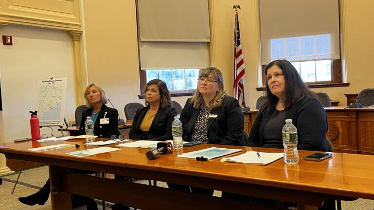 Four women that spoke to Maine lawmakers sit at a table.