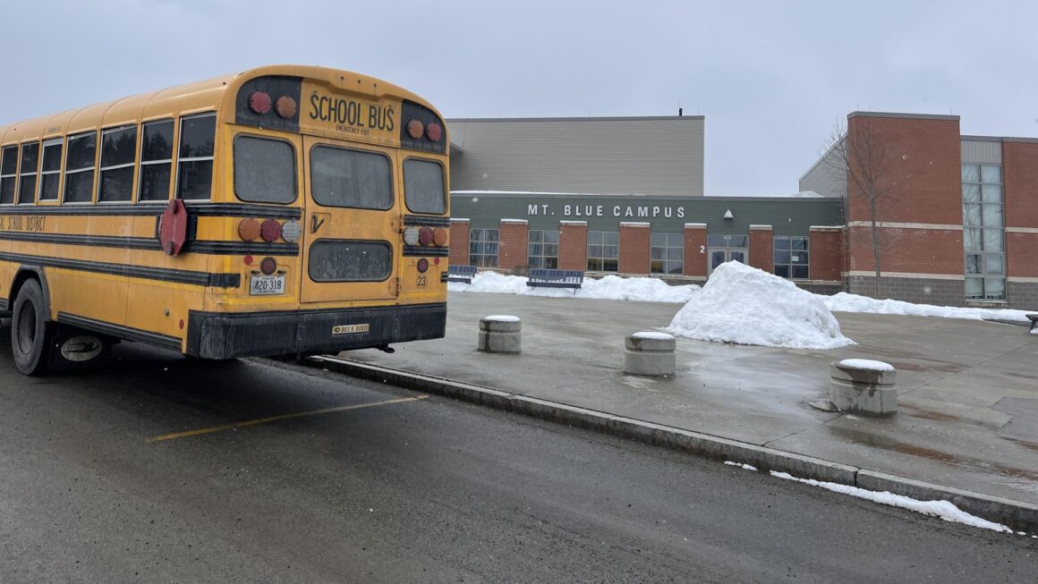 A yellow school bus sits outside the Mt. Blue campus.