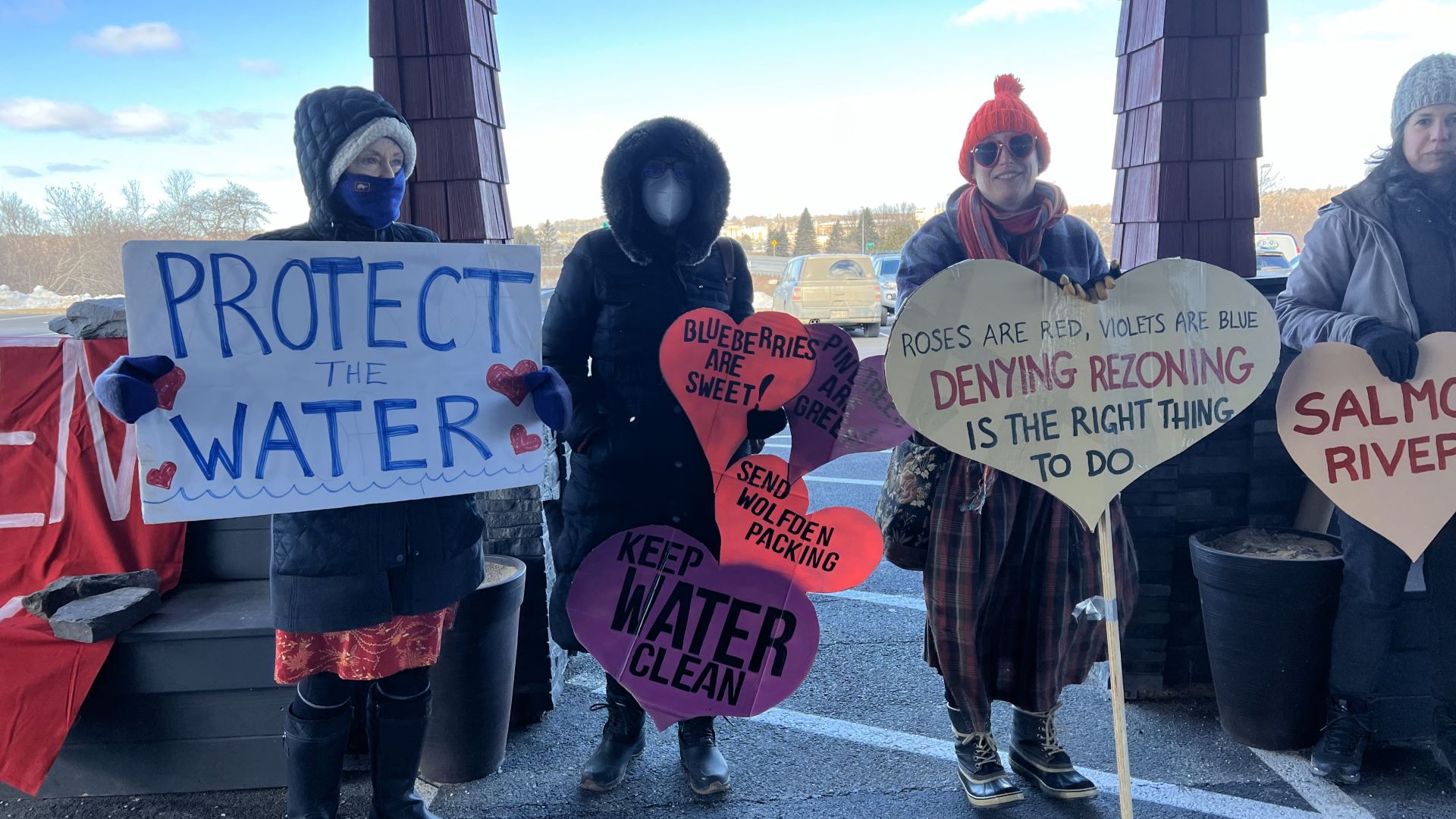 Activists holding signs to protest against the mining proposal.