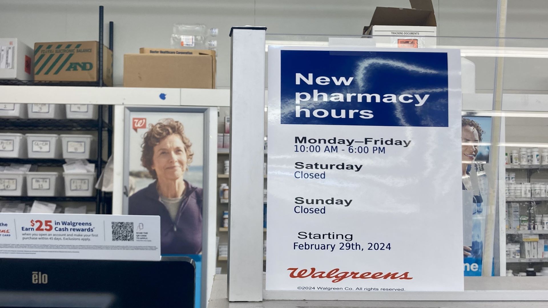 A sign listing the pharmacy's operating hours.