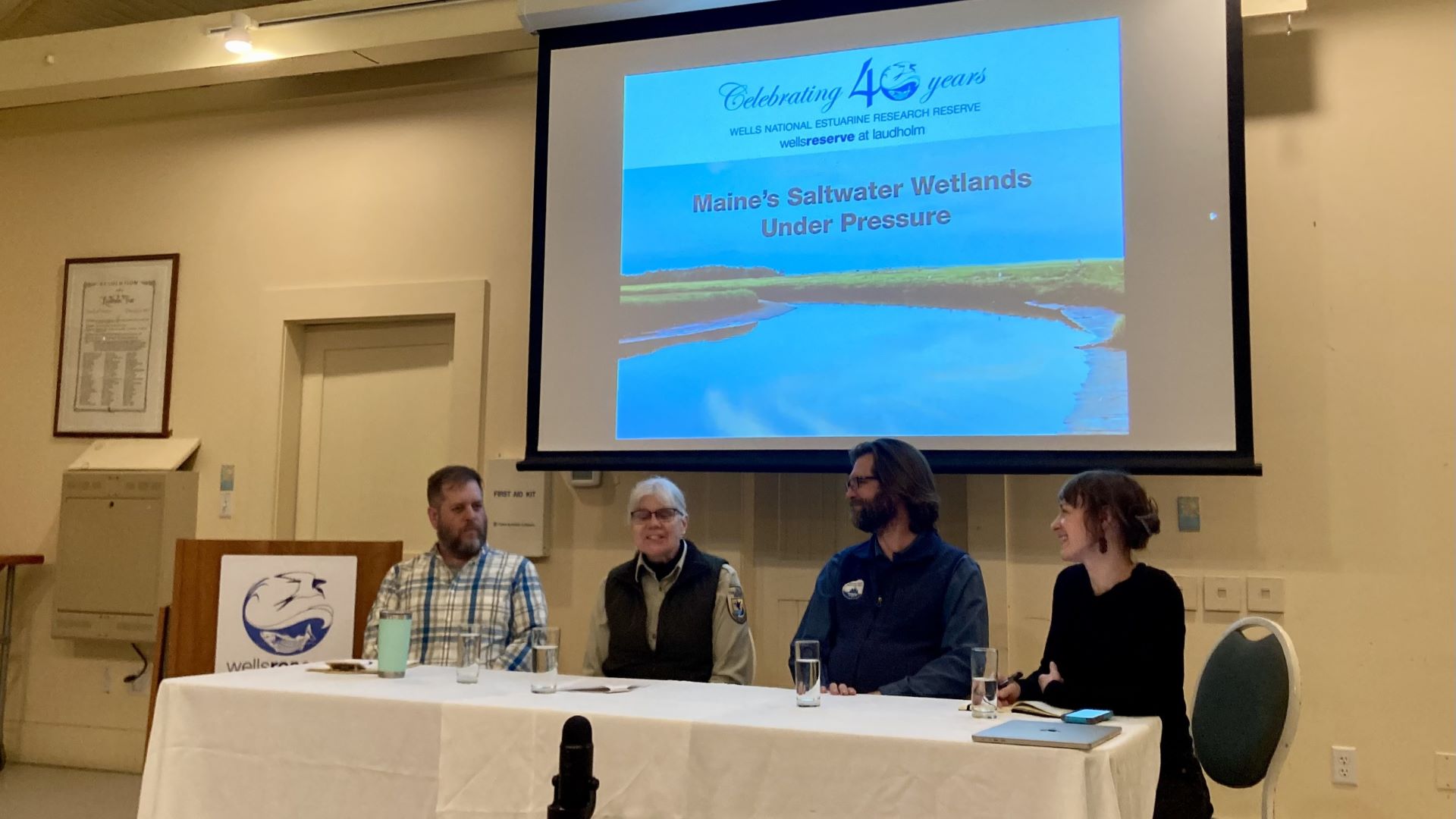 Four panelists sit a table during the event.