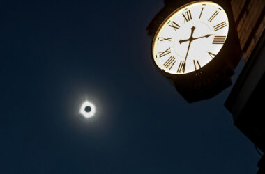 The solar eclipse as seen near a clock in Houlton, Maine.