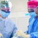Two surgeons participate in an operating room exercise.