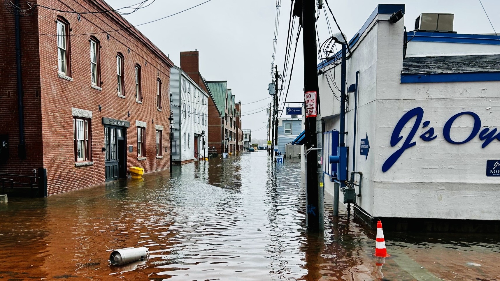 A road in Portland is flooded during high tide alongside J's Oysters.