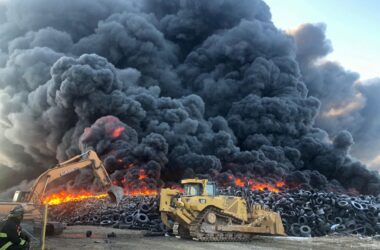 Large black clouds of a large group of tires on fire.