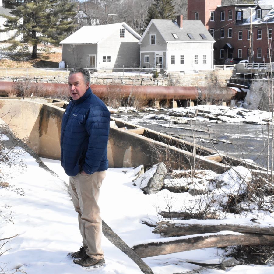 Alan Stearns poses for a photo by the Bridge Street Dam.