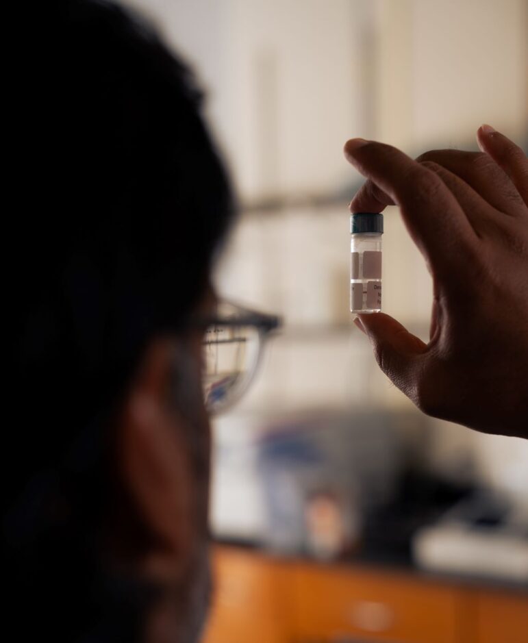 A man holds a sample vial of fentanyl.