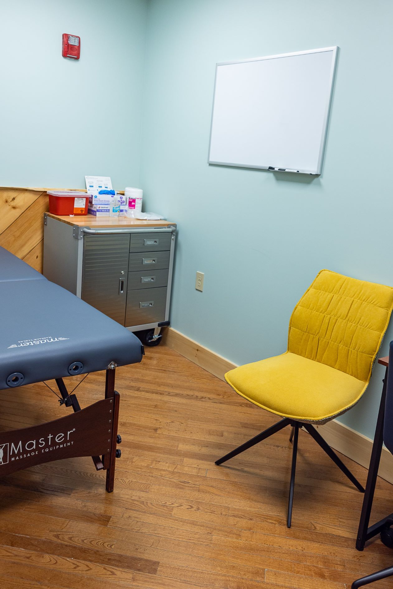 An examination table and other office equipment seen inside a clinical room at the Healing Lodge facility.