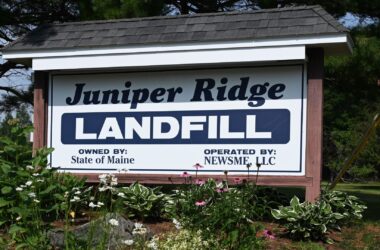 Sign at the entrance of the Juniper Ridge landfill. The sign reads Juniper Ride Landfill owned by State of Maine Operated By NewsMe, LLC.