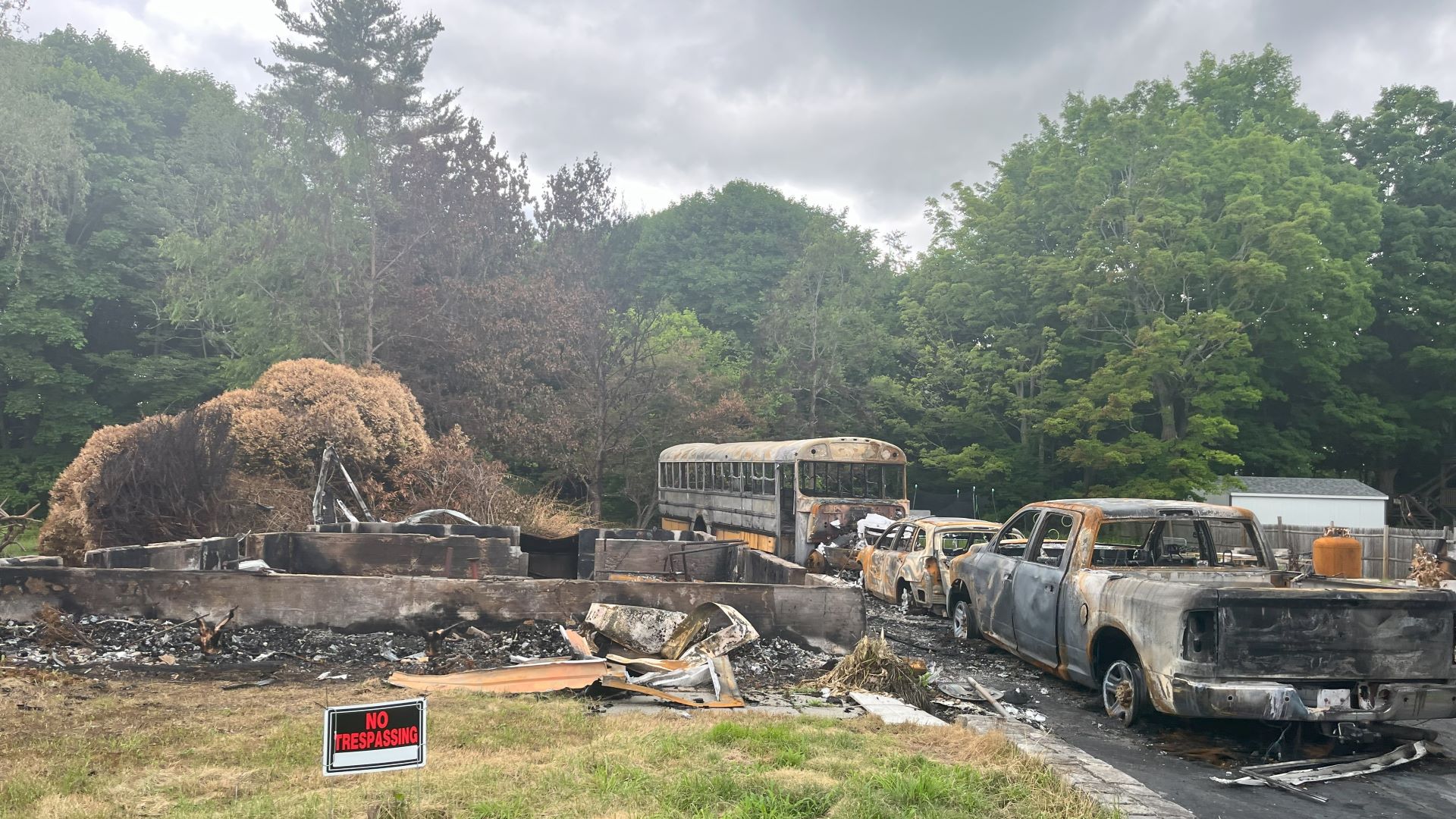 The charred remains of a home and vehicles. 