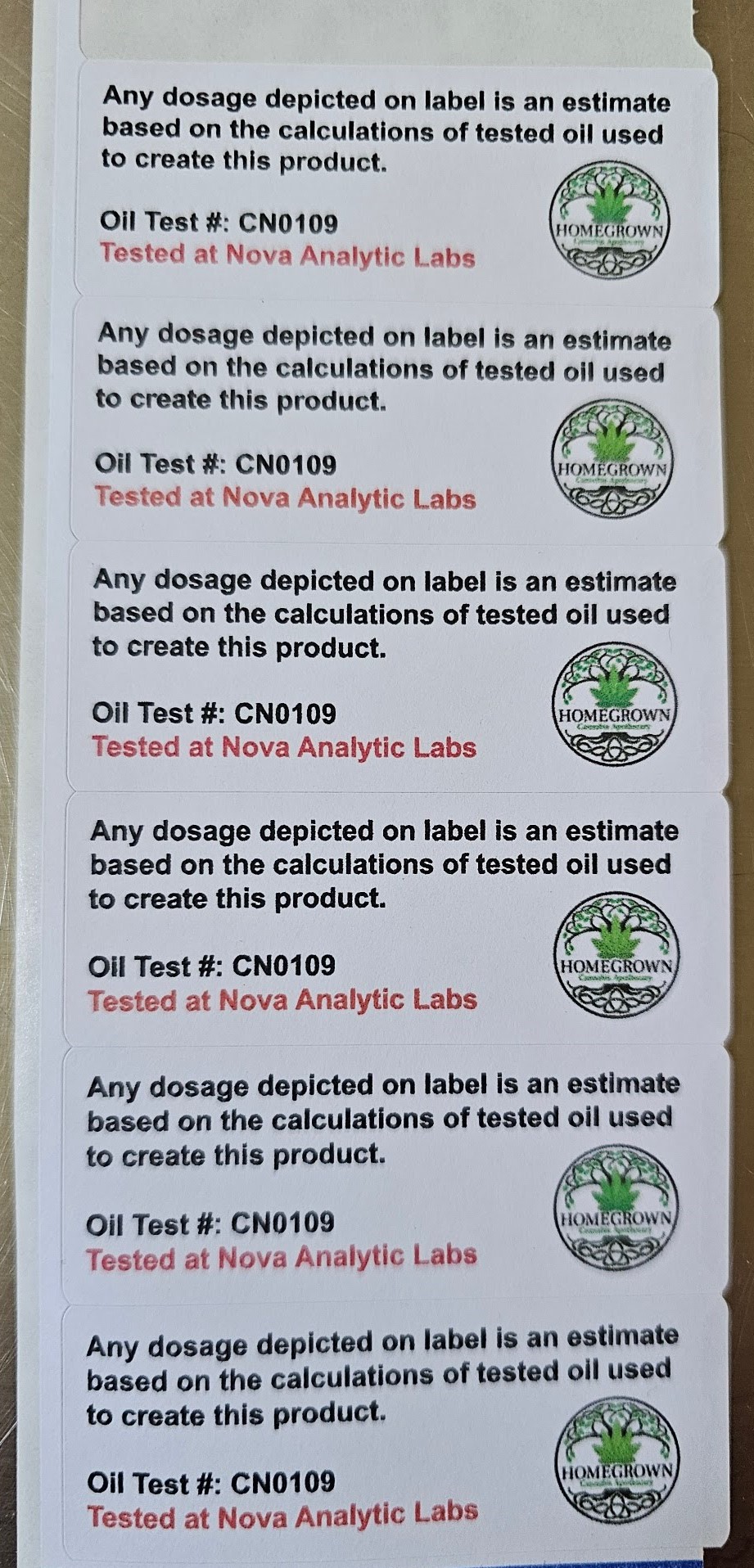 Label stickers that read: "Any dosage depicted on label is an estimate based on the calculations of tested oil used to create this product. Oil Test number CN 0109. Tested at Nova Analytic Labs."