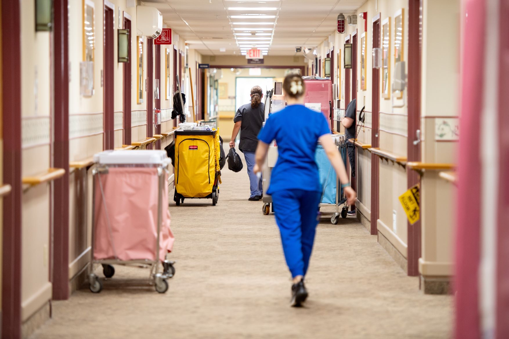 Employees walk through a hallway of the Caribou Rehab and Nursing Center.