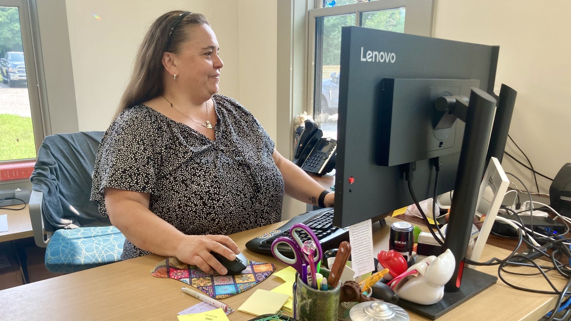 Lynn Osgood works at her desk.