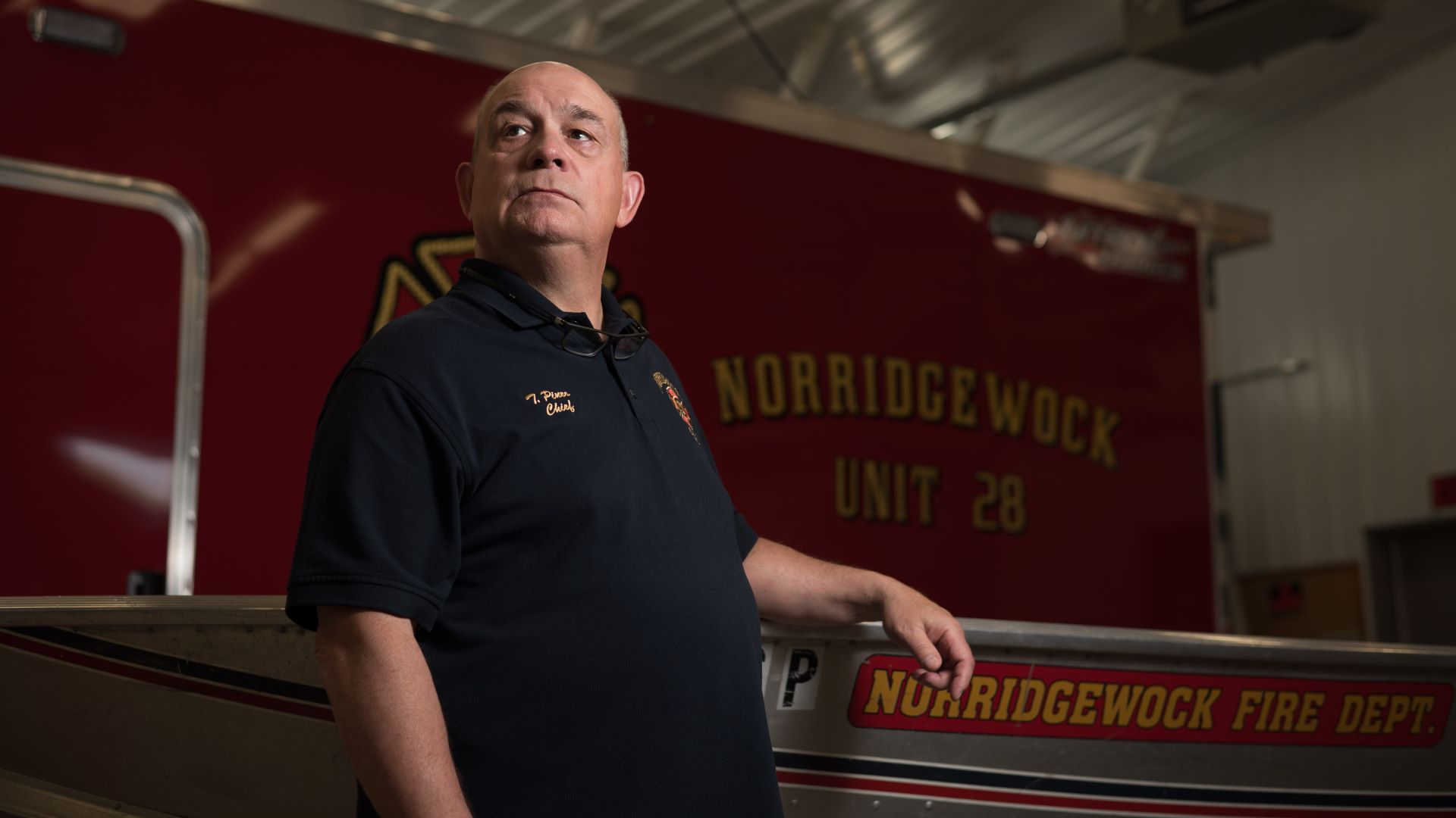 Todd Pineo poses for a photo in the fire station.