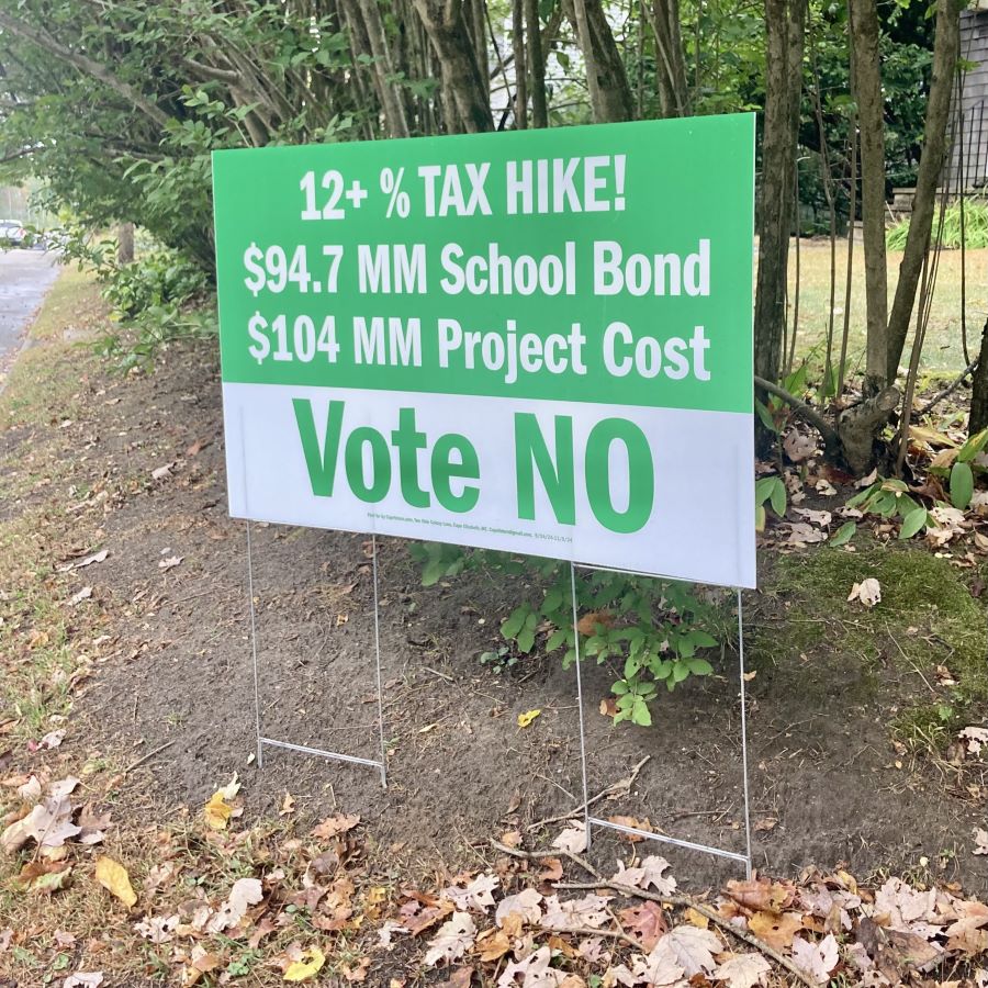 A sign encouraging voters to reject the school bond measure.