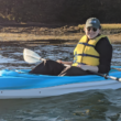 Annie Ropeik poses for a photo while sitting in a kayak.