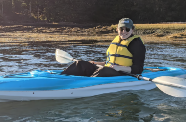 Annie Ropeik poses for a photo while sitting in a kayak.